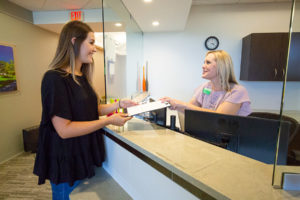 patient at reception desk